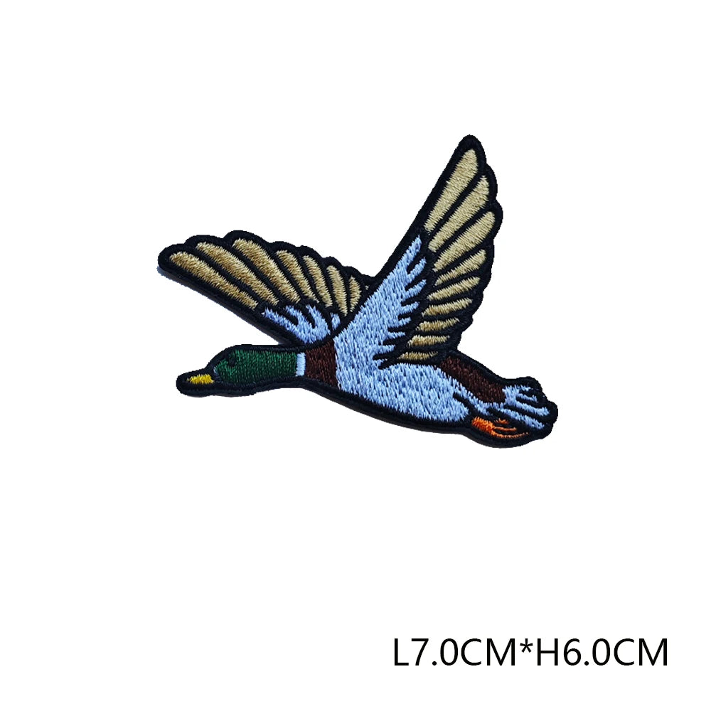 3D embroidered hunting patch featuring a blue and brown bird in flight