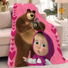 A cartoon bear and a child wearing a purple hood are featured on a pink fleece throw blanket.