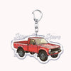 A red off-road truck model mounted on a durable metal key ring.