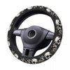 Black steering wheel cover with a skull design and anti-slip grip.