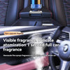 Close-up of a car interior showing a visible fragrance mist diffusing into the air from a diffuser.