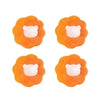 Four orange laundry balls shaped like dog heads used as reusable pet hair removers