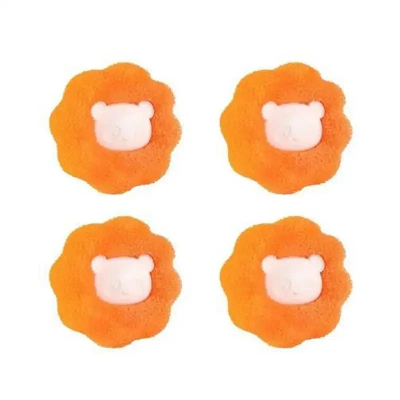 Four orange laundry balls shaped like dog heads used as reusable pet hair removers