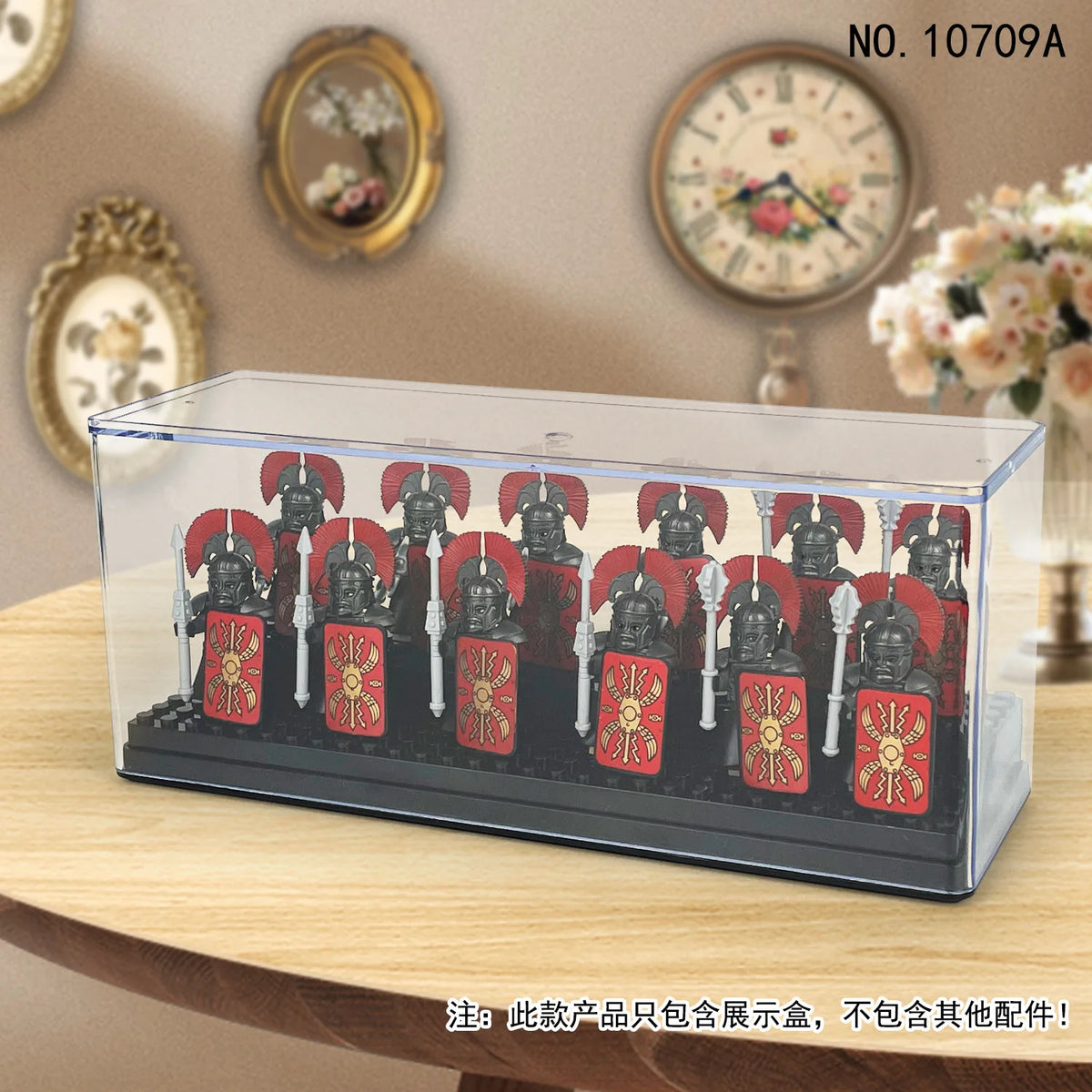 Clear acrylic display case featuring a collection of red and black figurines on a wooden surface.