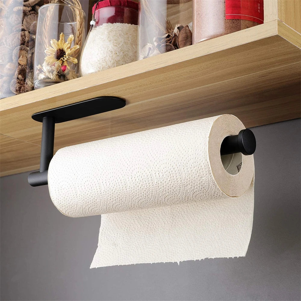 A white roll of toilet paper is displayed on a black adhesive stainless steel rack mounted under a wooden shelf.