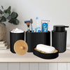 Matte black bathroom accessories set featuring a soap dispenser and brush holder on a light wood surface.