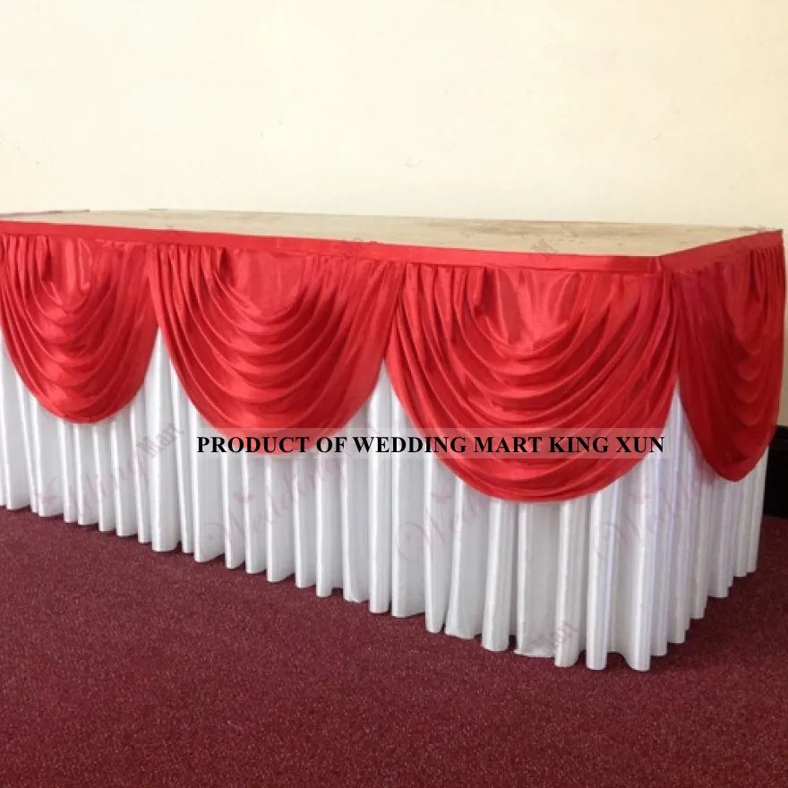 Elegant ice silk table skirt in red and white with matching top swag for a wedding market display