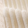 A close-up of a cream-colored plush anti-slip sofa cushion mat with vertical ribbed texture.