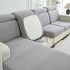 A light gray Jacquard stretch sofa slipcover with a white back cushion and non-slip grip.