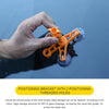 A hand holds an orange positioning bracket with two threaded holes over a dark surface.