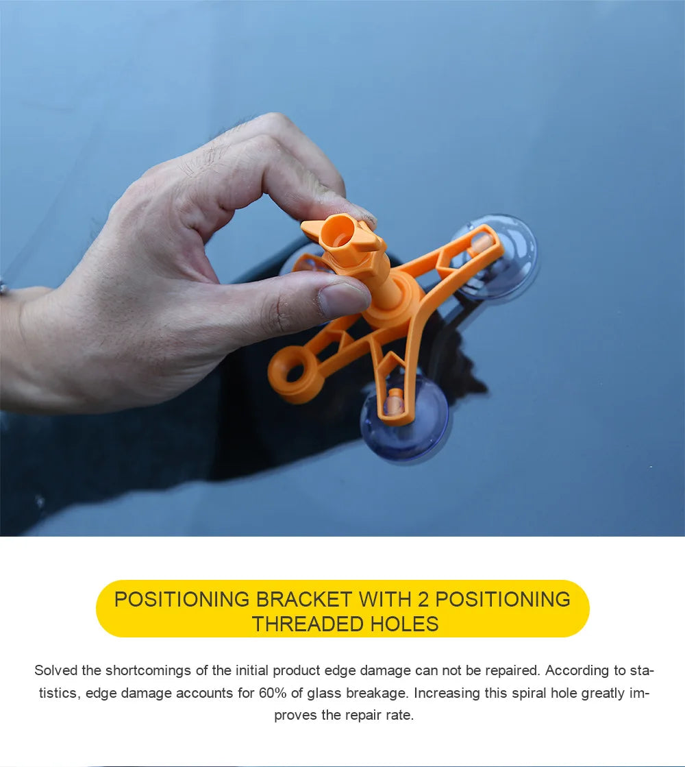 A hand holds an orange positioning bracket with two threaded holes over a dark surface.