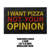 Black embroidered patch with yellow and red text that reads I WANT PIZZA NOT YOUR OPINION