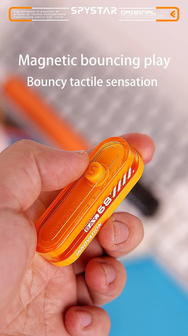 An orange magnetic bouncing play toy is held in a hand, demonstrating bouncy tactile sensation.