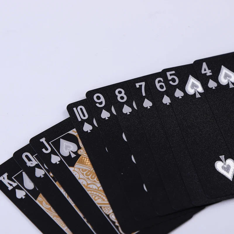 A stack of black playing cards showing the numbers 10 through Jack, with gold accents.