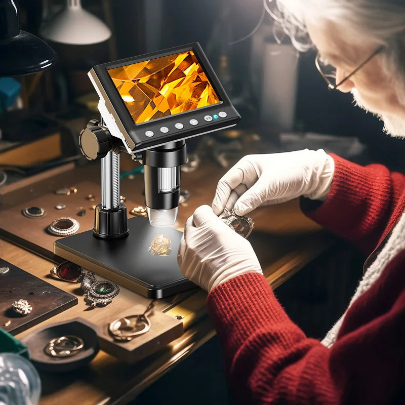 A person wearing white gloves is using a digital microscope to examine small jewelry pieces under bright illumination.