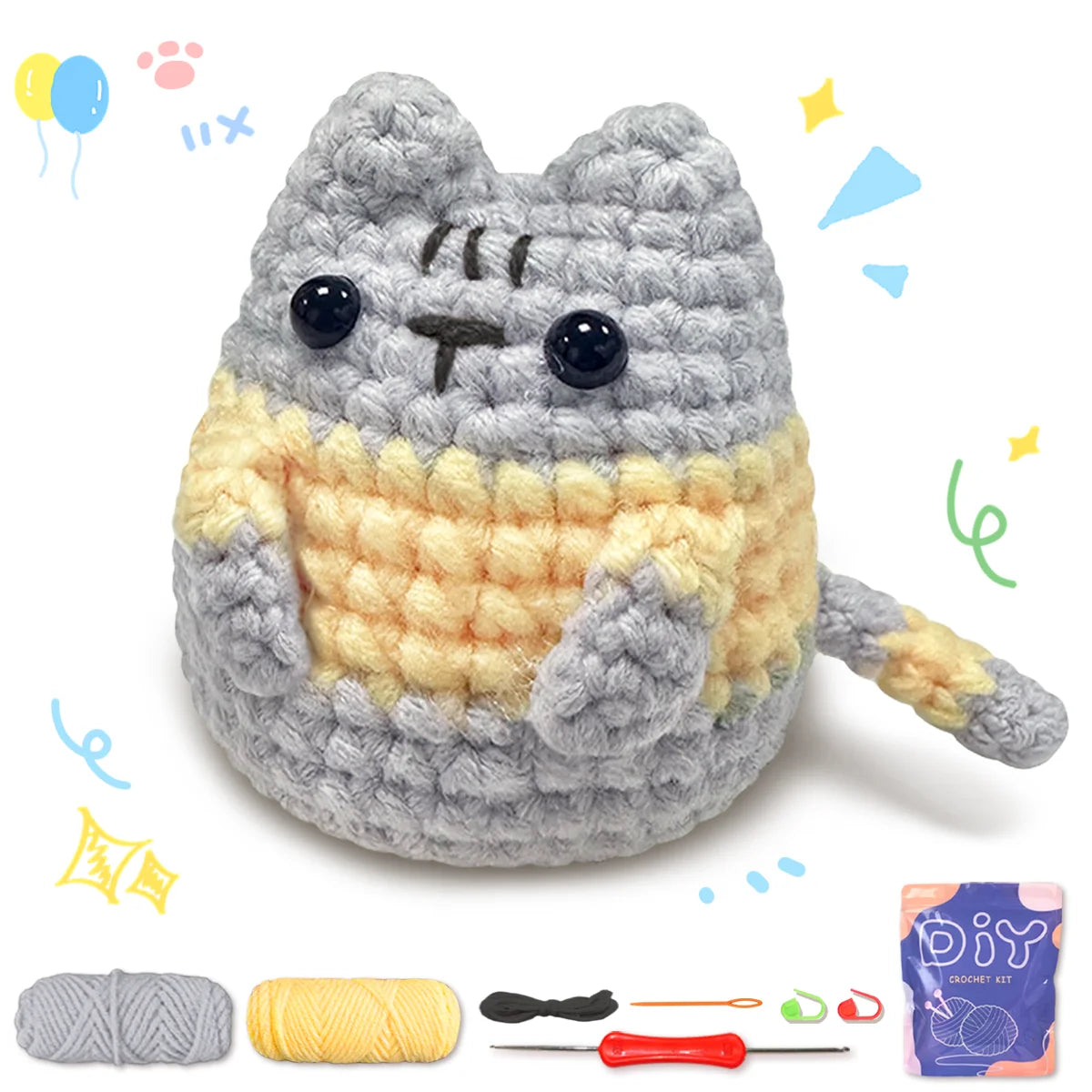 A finished gray and yellow cat amigurumi crochet toy next to yarn and tools.
