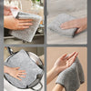 Hands are cleaning a stainless steel sink and a frying pan with gray bamboo charcoal microfiber kitchen cleaning cloths.