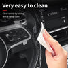 A hand wipes a carbon fiber pattern steering wheel cover with a damp cloth for easy cleaning.