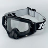 Black motorcycle goggles with a white strap are displayed against a white background.