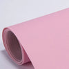 Roll of pink self-adhesive PU leather repair patches, showing the texture and roll.