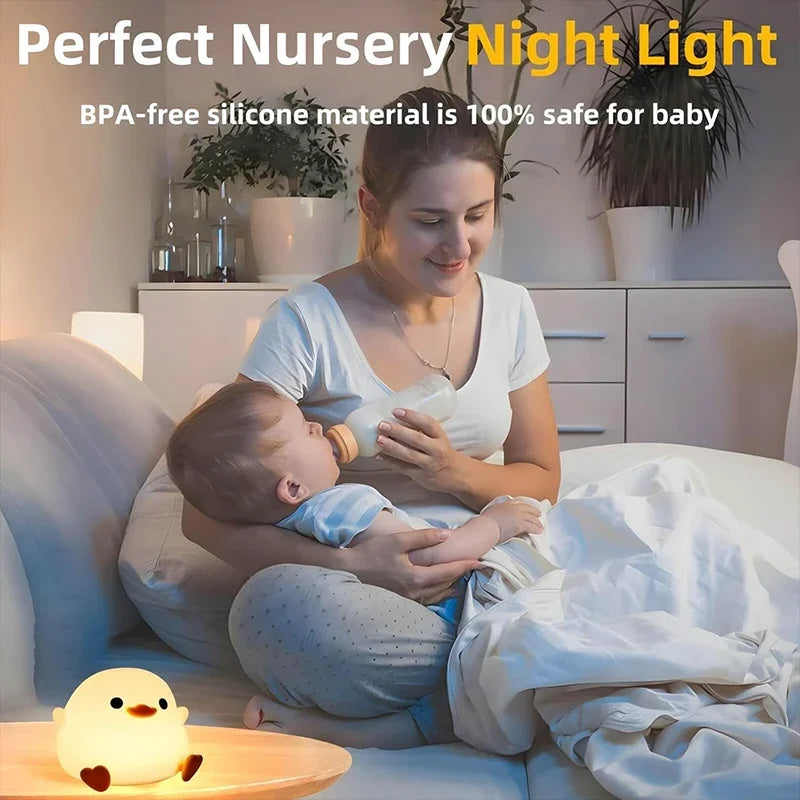 A woman gently holds a baby while using a cute duck night light for baby safety.