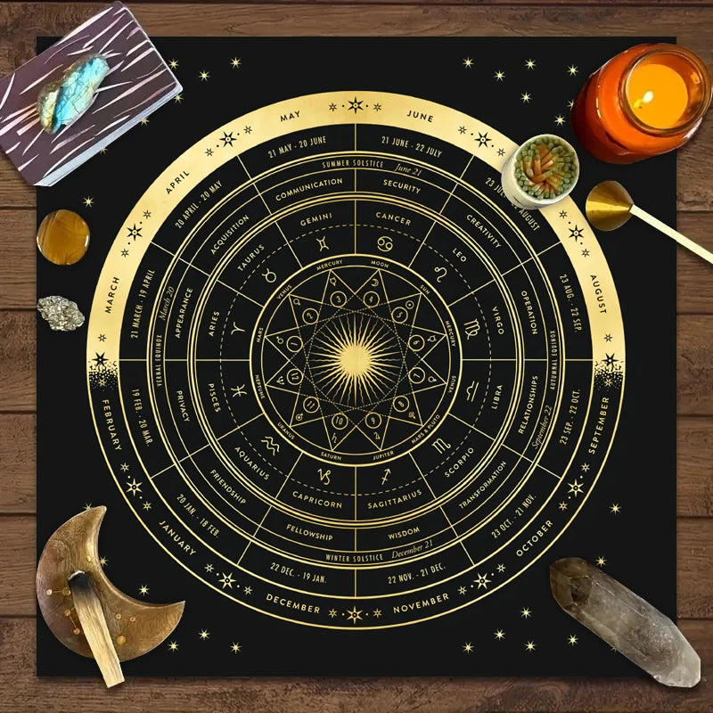 A dark fabric cloth featuring a detailed zodiac wheel with constellations and astrological signs for tarot readings