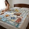 A plush throw blanket featuring cartoon animals and clouds is displayed on a bed.