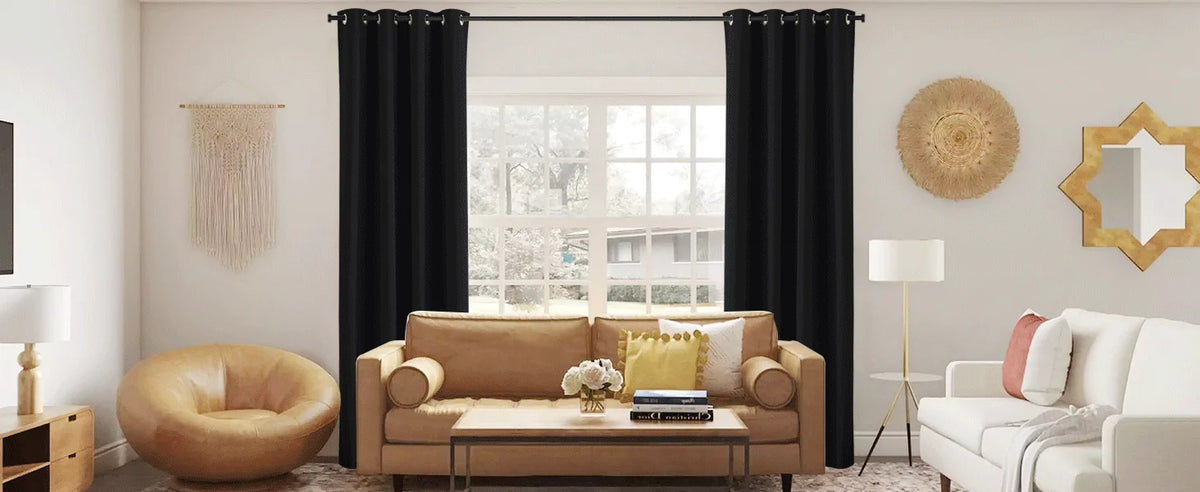 A living room features a beige sofa, a wooden coffee table, and black blackout curtain panels framing a window.