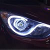 Close-up of a modern car headlight featuring a bright LED daytime running light design.