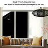 A black window is covered with a blackout privacy film, showing sunlight filtering through.