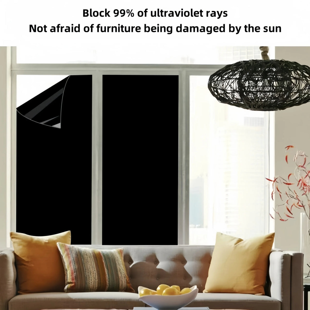 A black privacy window film is shown covering a window, with furniture visible in the foreground.