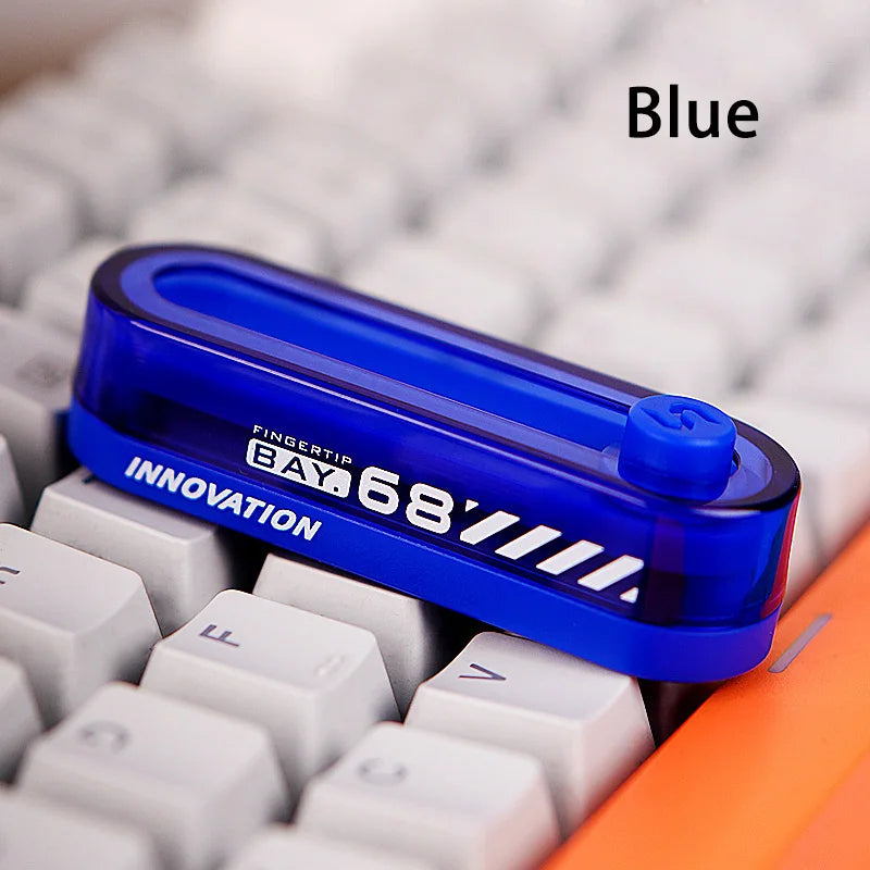 A blue metal fidget slider is shown resting on a white keyboard, with the word Blue visible.