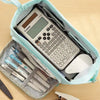 A light blue canvas pencil case is open, revealing a Canon calculator, pens, and a white mouse.