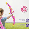 A child is demonstrating a pink and yellow bow and arrow set with suction cups, illustrating fine motor skills and hand-eye c