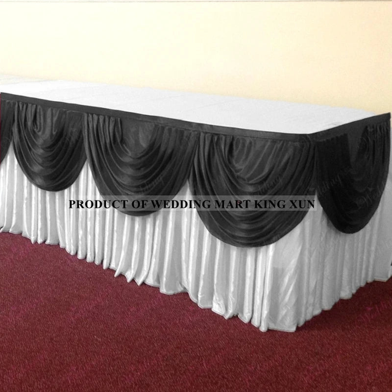 Elegant ice silk table skirt with matching top swag in black and white fabric.