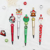 A craft kit featuring a beaded ballpoint pen with a Christmas theme, including various bead decorations and a festive topper.