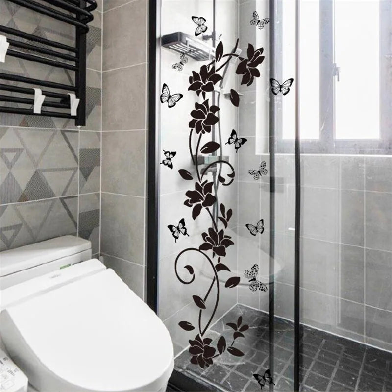 Black flower butterfly wall sticker applied to a glass shower door