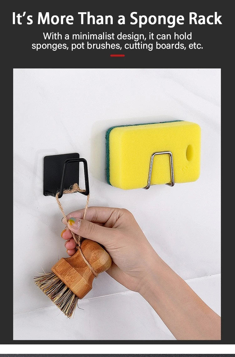 A hand holds a wooden brush attached to a black holder, demonstrating the sponge rack's functionality.