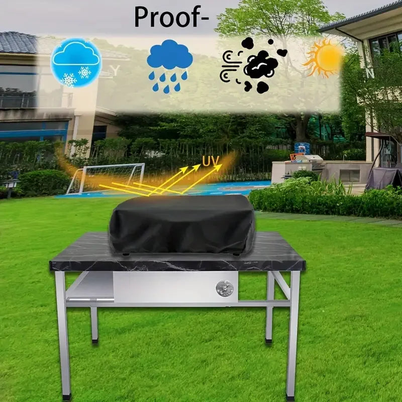 A black heavy-duty BBQ grill cover with a drawstring closure is placed on a metal table outdoors.