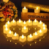 A collection of heart-shaped flameless LED candles arranged on a dark surface with a gold book in the background.