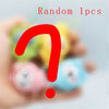 A hand holds a random assortment of cute PVC bag pendant dolls, including Usagi and Hachiware figures.