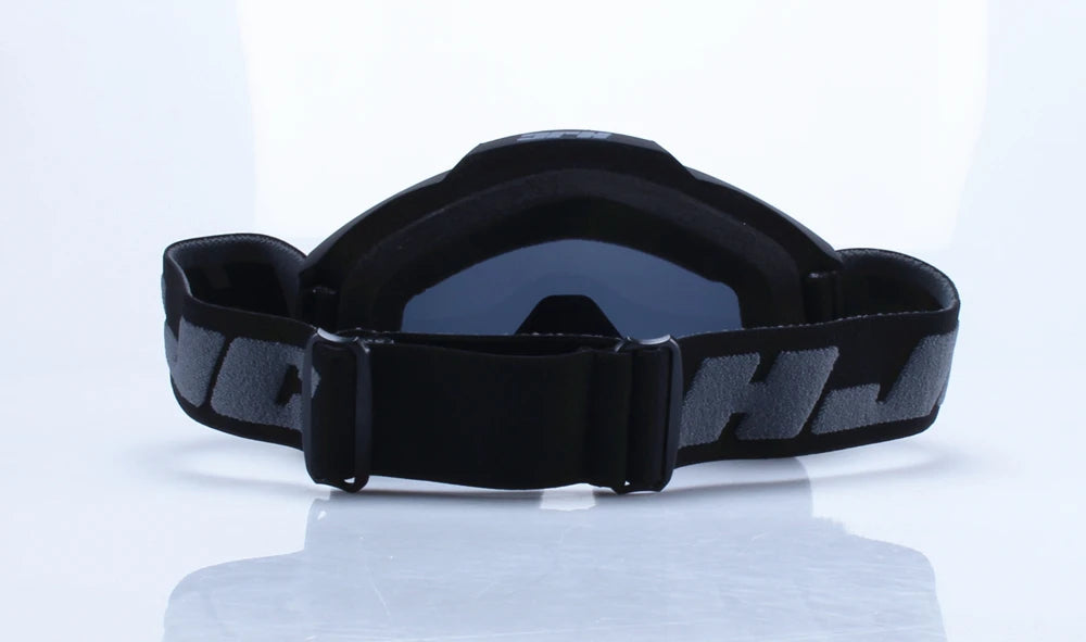Black retro motorcycle sunglasses with night vision lenses displayed on a reflective surface.
