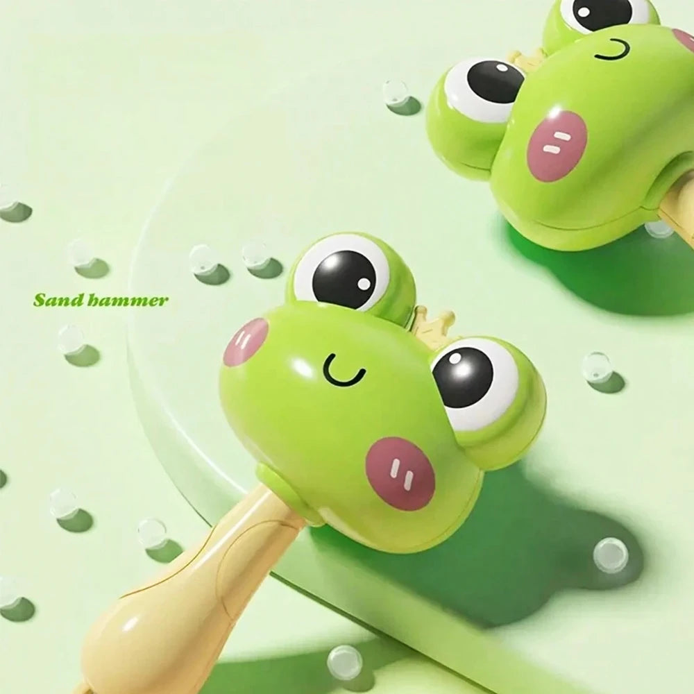 A lime green cartoon animal baby rattle with large eyes and a light wood handle resting on a green surface.