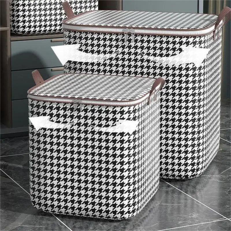 A pair of checkered fabric storage bags for clothes and quilts displayed on a dark surface.