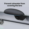 A black rain cover shield is shown protecting a car's rear camera lens from rainwater.