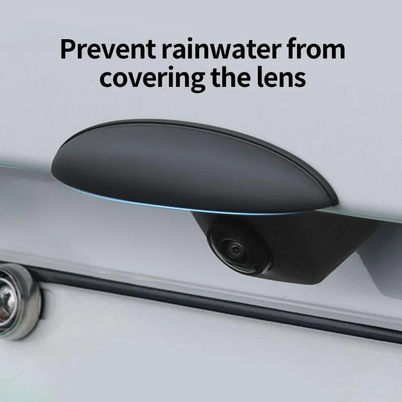 A black rain cover shield is shown protecting a car's rear camera lens from rainwater.