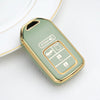 A light green TPU protective key case with gold accents resting on a white surface.