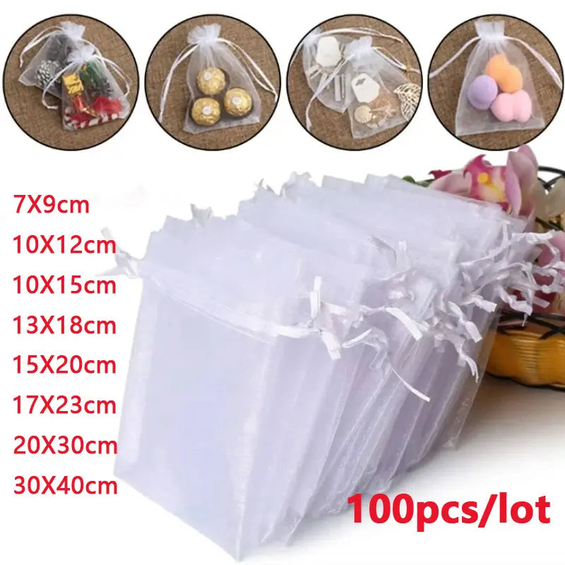 A set of 100 clear organza drawstring gift bags for jewelry and small items in various sizes