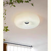 Modern donut LED wall sconce with touch dimming mounted on a white ceiling.