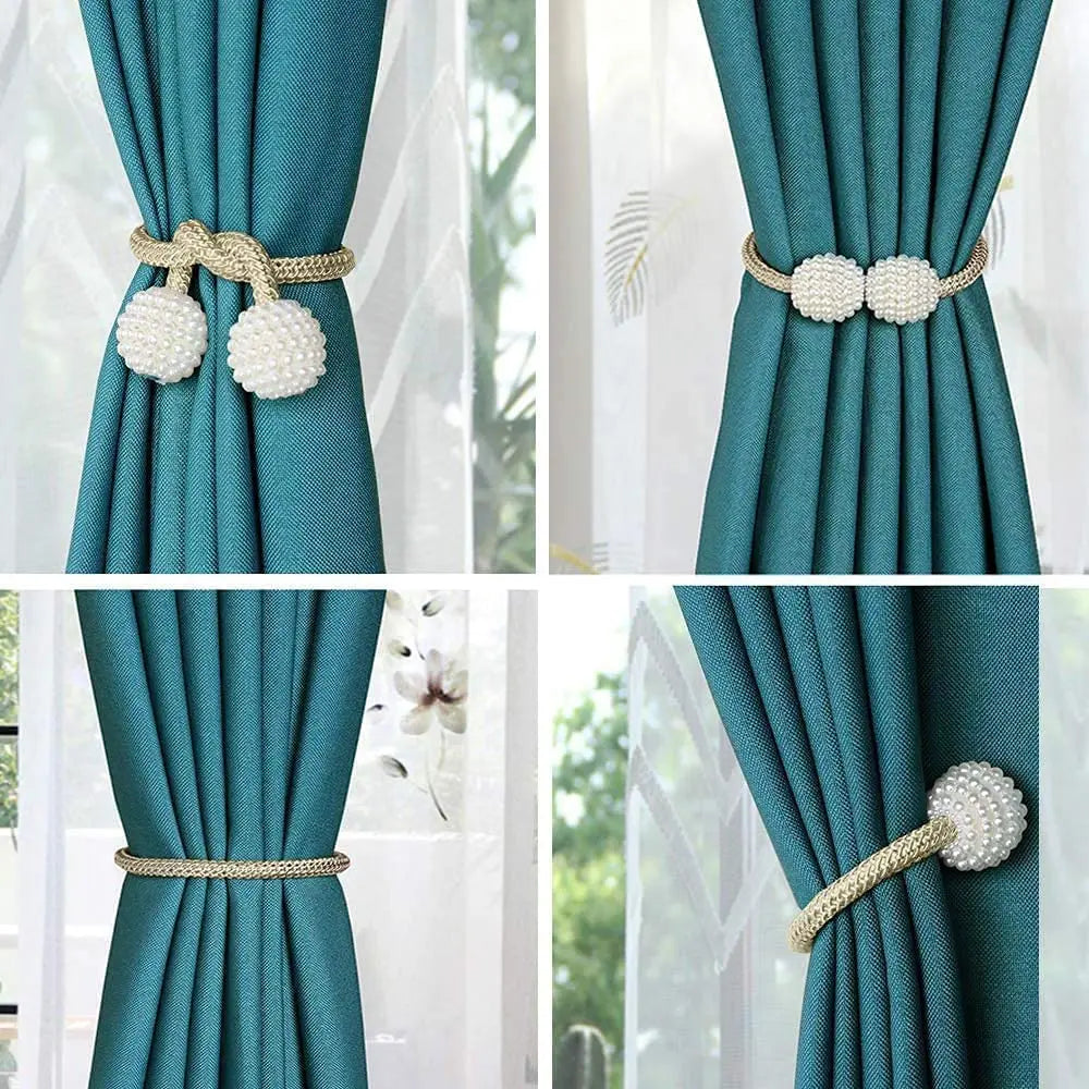 Close-up view of pearl magnetic curtain clips in gold and white on teal fabric.